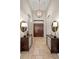 Grand foyer entrance with decorative lighting, double doors, and travertine flooring at 13208 Malachite Dr, Bradenton, FL 34211