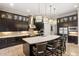 Modern kitchen with large island, stainless steel appliances, and dark wood cabinetry at 13208 Malachite Dr, Bradenton, FL 34211