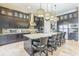 Modern kitchen with island and bar seating, stainless appliances, and dark wood cabinets at 13208 Malachite Dr, Bradenton, FL 34211