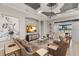 Comfortable living room featuring stone accent wall, tray ceilings, and beautiful tile floors at 13208 Malachite Dr, Bradenton, FL 34211