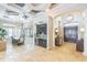 Open-concept living space with a dining table, wet bar and arched entry to the front door and foyer at 13208 Malachite Dr, Bradenton, FL 34211