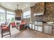 Outdoor kitchen featuring a built-in BBQ, stainless steel appliances, and stone counters at 13208 Malachite Dr, Bradenton, FL 34211