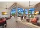 Enclosed patio with an outdoor seating area and views of the lake and the pool at 13208 Malachite Dr, Bradenton, FL 34211