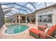 Outdoor living with brick pool deck, kitchen, and comfortable furniture at 13208 Malachite Dr, Bradenton, FL 34211