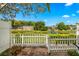 Charming backyard patio with white picket fence overlooking the serene community lake at 13696 Orange Sunset Dr # 13696, Tampa, FL 33618