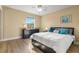 Relaxing bedroom with hardwood floors, a ceiling fan, and a window with a view at 13696 Orange Sunset Dr # 13696, Tampa, FL 33618