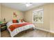 Cozy bedroom with hardwood floors, a ceiling fan, and a window with a nice backyard view at 13696 Orange Sunset Dr # 13696, Tampa, FL 33618