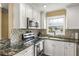 The renovated kitchen offers granite countertops, stainless steel appliances, and ample cabinet space at 13696 Orange Sunset Dr, Tampa, FL 33618