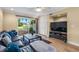 Cozy living room featuring a ceiling fan, wood floors, and sliding glass doors to a patio with a white picket fence at 13696 Orange Sunset Dr # 13696, Tampa, FL 33618