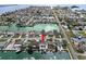 Waterfront property aerial showcasing a private pool, dock access, and serene canal views at 13704 Evelane Dr, Hudson, FL 34667