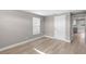 Empty room with white walls and trim, light laminate floors, and a single window at 13704 Evelane Dr, Hudson, FL 34667