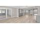 Open-concept living area featuring light wood flooring, recessed lighting, and access to an enclosed patio at 13704 Evelane Dr, Hudson, FL 34667