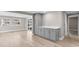 Open-concept living area with new flooring, gray walls, leading to a dining and kitchen area at 13704 Evelane Dr, Hudson, FL 34667