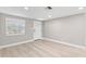 Bright living room with light wood floors, a front door with decorative glass, and large window at 13704 Evelane Dr, Hudson, FL 34667