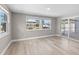 Bright living room with wood floors, natural light, and sliding door access to the patio at 13704 Evelane Dr, Hudson, FL 34667