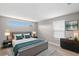 Bright main bedroom featuring a queen bed, stylish furniture, and a neutral color palette at 13704 Evelane Dr, Hudson, FL 34667