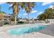 Relaxing pool with waterfront views and dock access, surrounded by lush tropical landscaping at 13704 Evelane Dr, Hudson, FL 34667