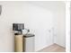 Utility room with water softener unit, laminate floors, and white walls at 13704 Evelane Dr, Hudson, FL 34667