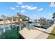 Scenic waterfront view with a dock and boat lift, perfect for boating enthusiasts at 13704 Evelane Dr, Hudson, FL 34667