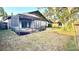 Spacious backyard featuring a screened-in patio with a charming round brick-lined fire pit and ample green space at 1510 Sakonnet Ct, Brandon, FL 33511