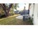 A serene backyard with a screened-in patio, a circular fire pit, and a privacy fence, ideal for outdoor relaxation at 1510 Sakonnet Ct, Brandon, FL 33511