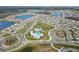 Aerial view of planned community featuring multiple pools, ponds, parks, and playgrounds amid residential housing at 15959 Tuscany Hillside Rd, Odessa, FL 33556