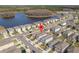Aerial view of home in a neighborhood close to a lake; includes surrounding houses, and street view at 15959 Tuscany Hillside Rd, Odessa, FL 33556