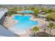 Aerial view of an expansive resort-style community pool area featuring lounge chairs and shaded pergola area at 15959 Tuscany Hillside Rd, Odessa, FL 33556