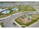 Aerial view of community featuring a pool, playground, park, parking lot, and residential homes at 15959 Tuscany Hillside Rd, Odessa, FL 33556