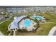 Aerial view of community clubhouse featuring a large resort-style pool, seating, and shaded pergola area at 15959 Tuscany Hillside Rd, Odessa, FL 33556