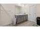 Bathroom featuring dual sinks, white countertops, and gray cabinets at 15959 Tuscany Hillside Rd, Odessa, FL 33556