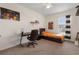 Comfortable bedroom with desk, orange bedding, and natural light from window at 15959 Tuscany Hillside Rd, Odessa, FL 33556