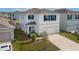 Lovely two-story home with a two-car garage, blue shutters, and manicured landscaping at 15959 Tuscany Hillside Rd, Odessa, FL 33556