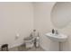 Half bathroom featuring toilet, pedestal sink and round mirror at 15959 Tuscany Hillside Rd, Odessa, FL 33556