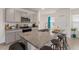 Stylish kitchen island with granite countertop and seating in this home's open floor plan at 15959 Tuscany Hillside Rd, Odessa, FL 33556