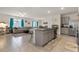 Modern kitchen with granite countertops, a central island, and stainless steel appliances at 15959 Tuscany Hillside Rd, Odessa, FL 33556