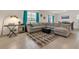 Spacious living room with a large sectional sofa, accent rug, and modern decor at 15959 Tuscany Hillside Rd, Odessa, FL 33556