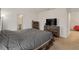 Spacious bedroom featuring rustic wood furnishings, neutral carpet, and modern TV at 15959 Tuscany Hillside Rd, Odessa, FL 33556