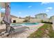 Private in-ground pool, surrounded by pavers with lounge chairs and umbrella, set against a fenced backyard at 15959 Tuscany Hillside Rd, Odessa, FL 33556