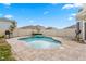 Private in-ground pool, surrounded by pavers and fence with lounge chairs and umbrella in a backyard at 15959 Tuscany Hillside Rd, Odessa, FL 33556