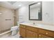 Functional bathroom with a shower, a toilet, and a vanity with a large mirror at 1605 W Dorchester Dr, Palm Harbor, FL 34684