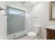 Bright bathroom with shower featuring herringbone tile and a modern toilet and vanity at 1605 W Dorchester Dr, Palm Harbor, FL 34684