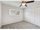Inviting bedroom with soft gray carpet, a ceiling fan, and ample natural light from the window at 1605 W Dorchester Dr, Palm Harbor, FL 34684