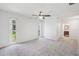 Spacious bedroom with plush carpeting, a ceiling fan, and two windows for plenty of natural light at 1605 W Dorchester Dr, Palm Harbor, FL 34684