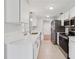 Stylish kitchen featuring stainless steel appliances, white cabinets, and granite countertops at 1605 W Dorchester Dr, Palm Harbor, FL 34684