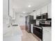 Modern kitchen with stainless steel appliances, sleek countertops, and white cabinetry at 1605 W Dorchester Dr, Palm Harbor, FL 34684