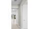 Bright hallway with neutral paint, tile floors, and an open view into other rooms at 1770 Pepper Grass Dr, North Port, FL 34289