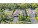 Aerial view of home with screened pool, mature landscaping, and charming curb appeal at 1824 Oak Ridge Rd, Safety Harbor, FL 34695