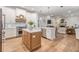 Open concept kitchen features an island, stainless steel appliances, and sightlines into the living room at 1824 Oak Ridge Rd, Safety Harbor, FL 34695