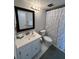 Well-lit bathroom with a vanity, mirror, and shower with curtain at 18304 Gulf Blvd # 309, Redington Shores, FL 33708